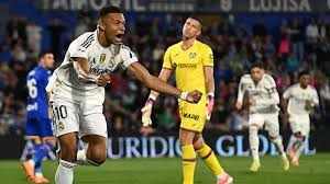 Kylian Mbappe scored the only goal as Real Madrid beat nine-man Getafe to move above reigning champions Barcelona and return to the top of La Liga.