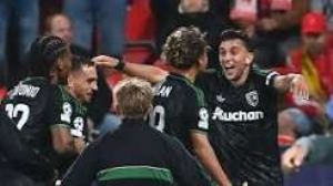 Lens scored two goals in stoppage time as they came from behind twice to beat 10-man Slavia Prague.