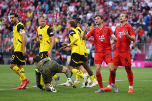 Bayern Munich missed the chance to move eight points clear at the top of the Bundesliga table as they were held to a draw by Borussia Dortmund in a pulsating game.